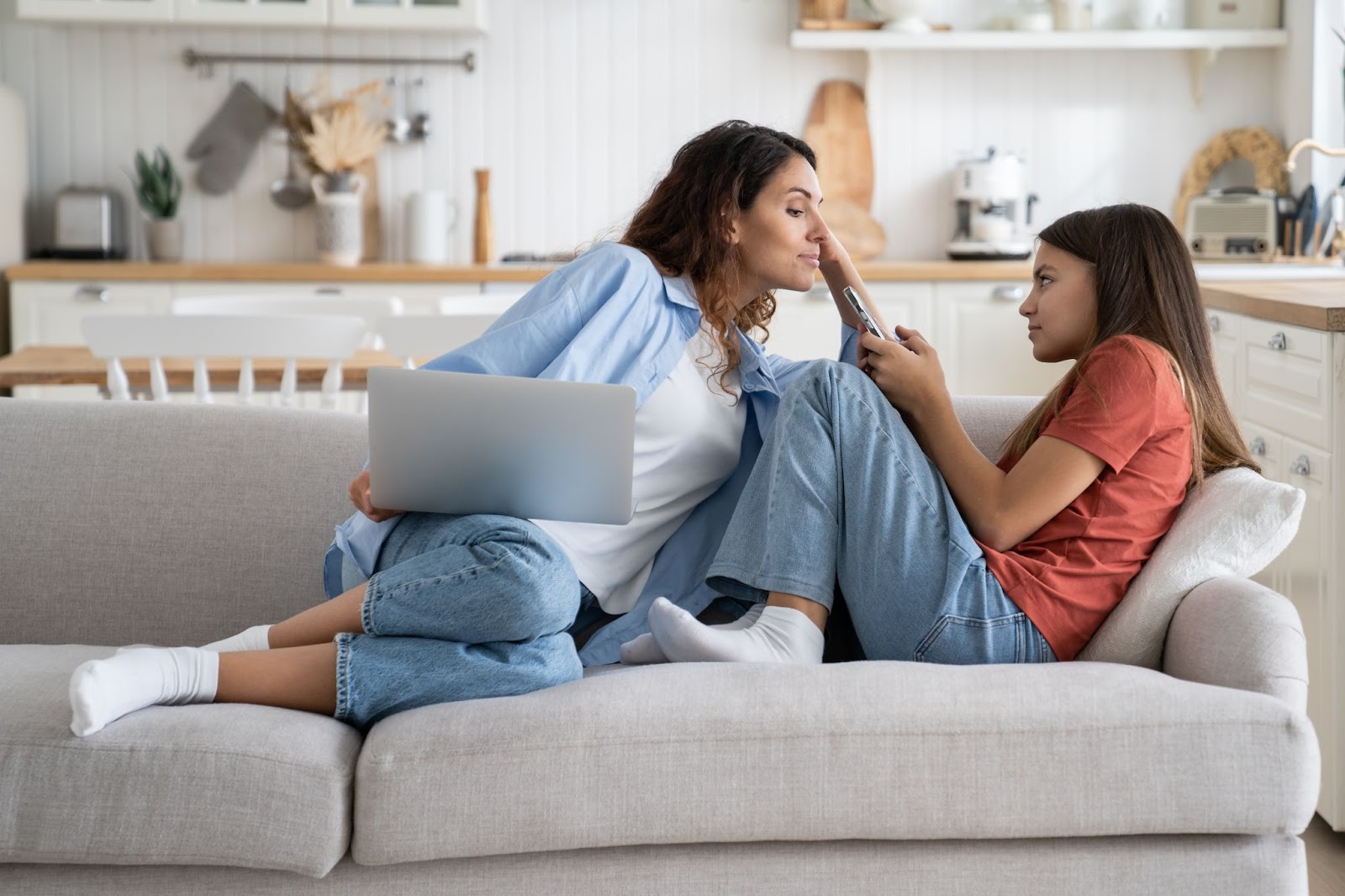 A foster parent showing care by checking the social media on the child's phone